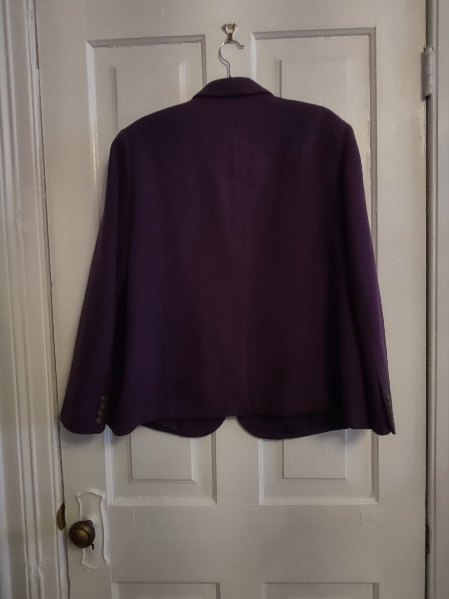 Purple jacket draped over a white door