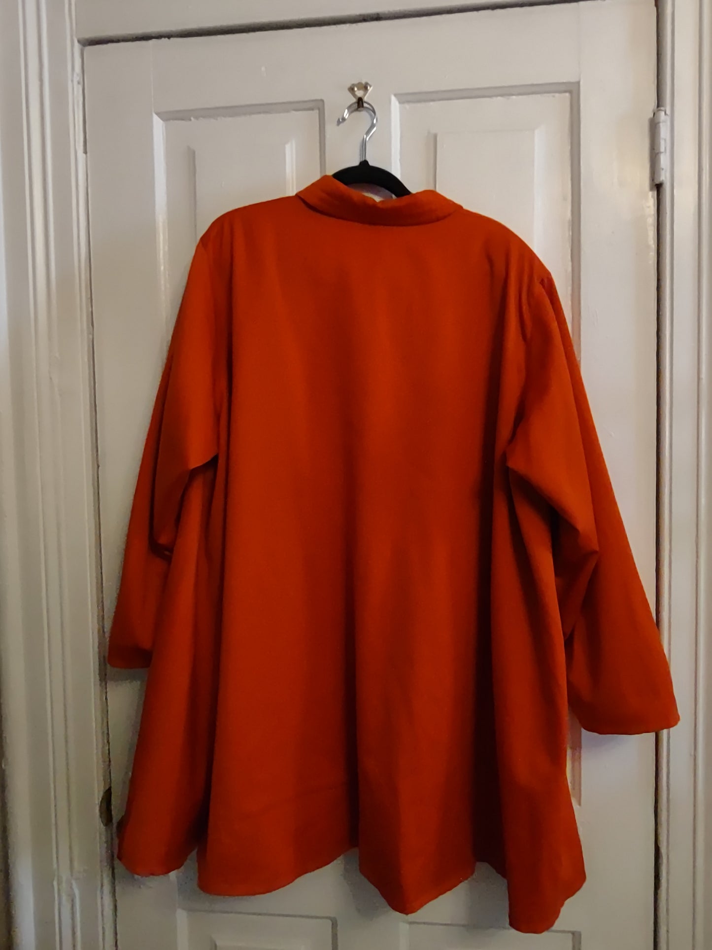 Back of orange coat on a white background.